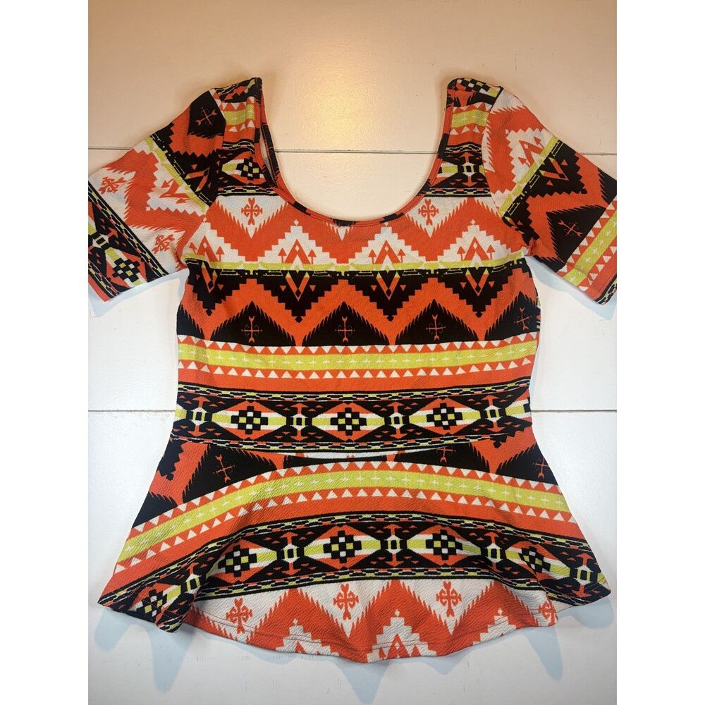 Orange tribal print peplum top